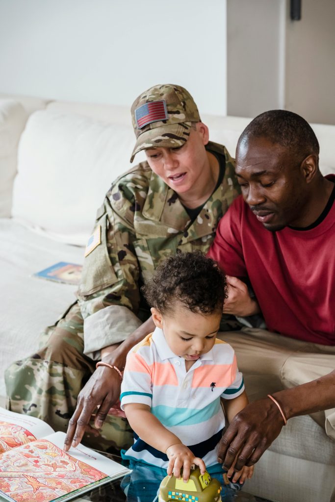 A heartwarming moment of a family with a military parent and child bonding in the living room.